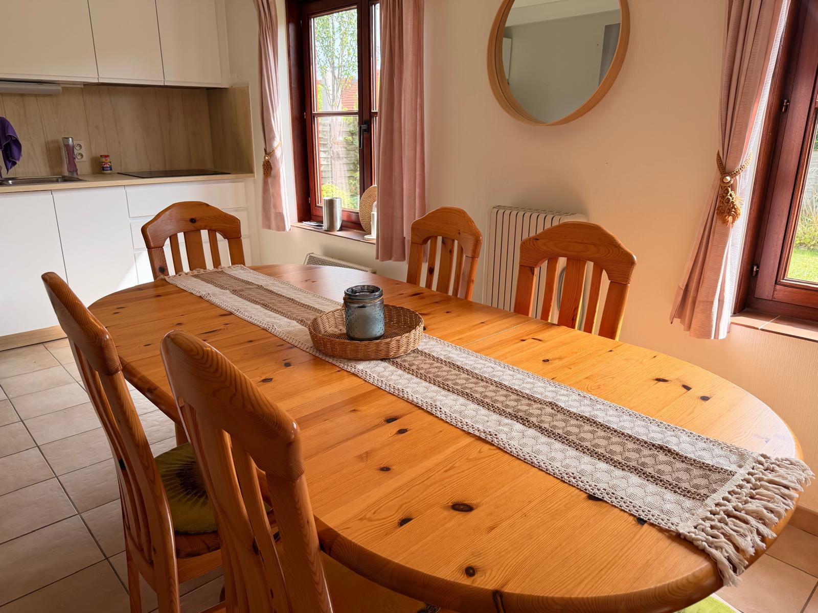 Dining table with six chairs next to the kitchen