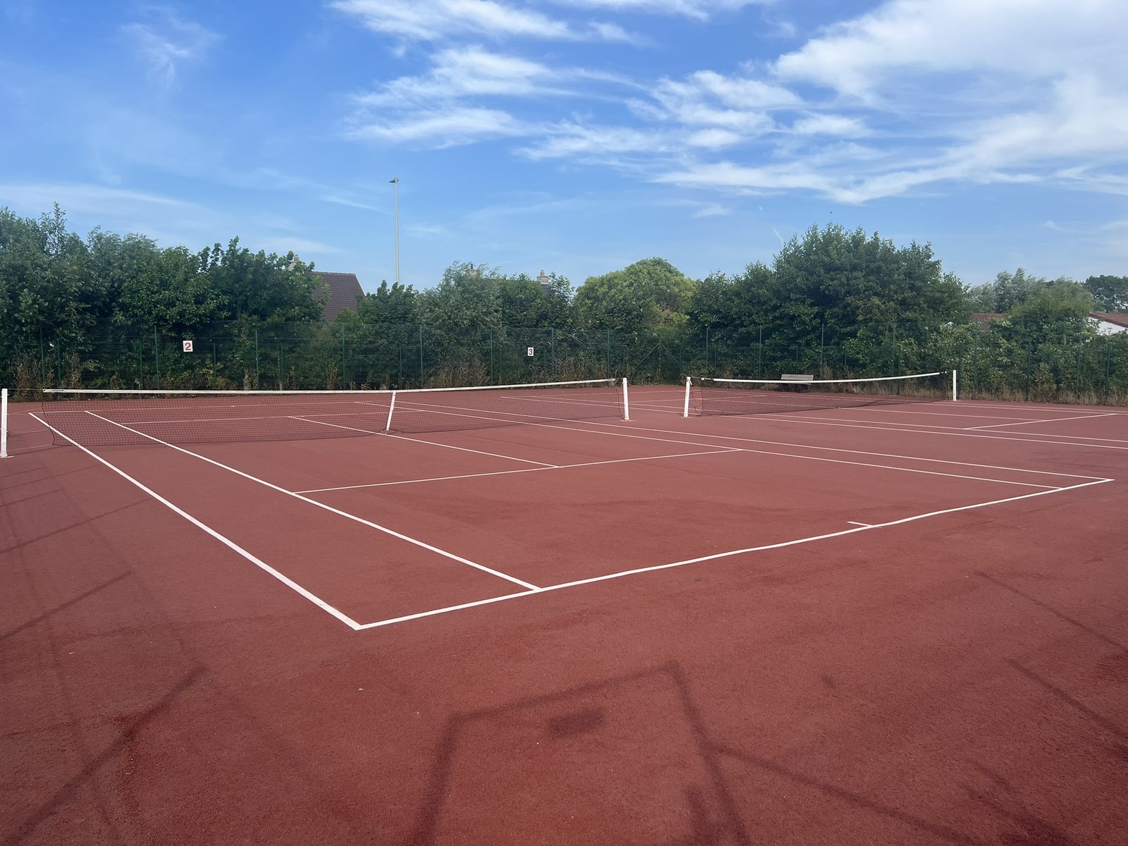 Shared tennis courts at Zeewind II Holiday Park